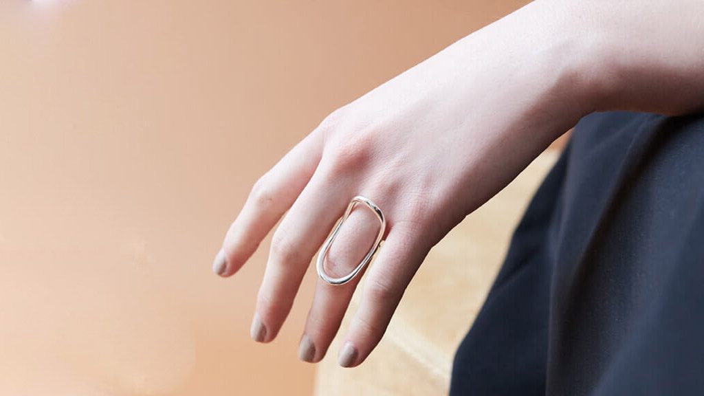 A person wearing a ring on their finger